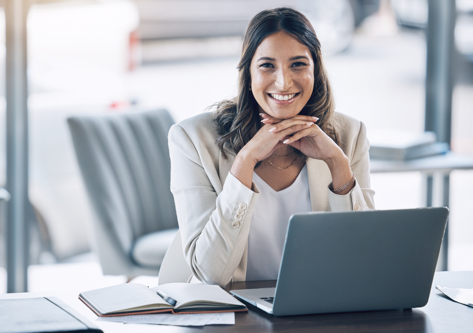 Calm, confident entrepreneur smiling at her laptop