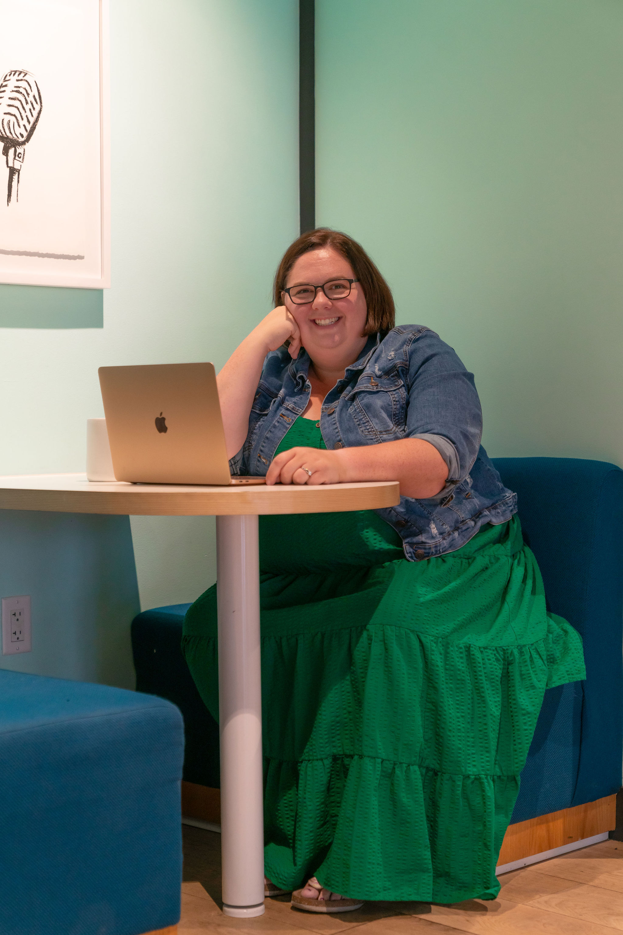 Adrienne Farrow smiling with her laptop